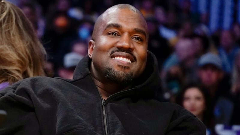 FILE - Kanye West watches the first half of an NBA basketball game between the Washington...