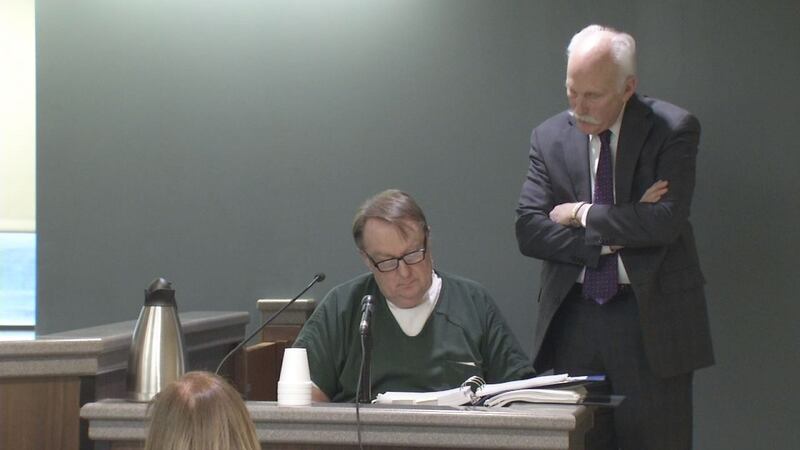 Jerry Burns, left, takes the stand in his own defense for an evidence suppression hearing on...