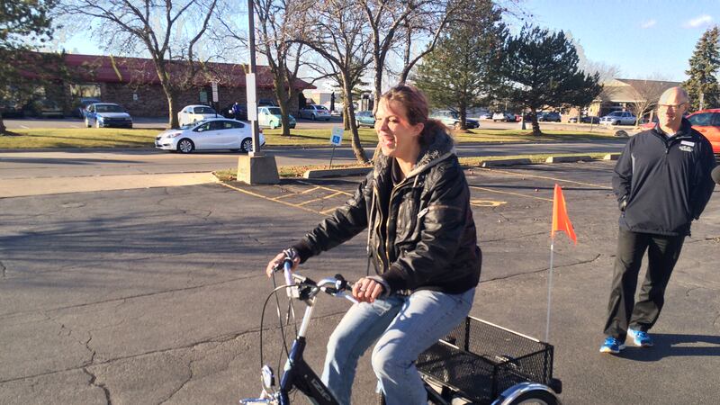 Bridget Kuhlman checks out her new ride in a parking lot. The disabled Cedar Rapids woman had...