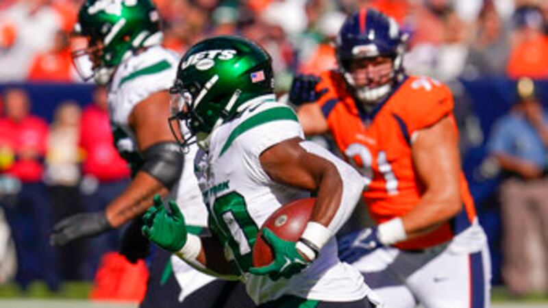 New York Jets running back Breece Hall (20) runs for the end zone against the Denver Broncos...