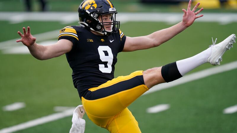 FILE - Iowa punter Tory Taylor punts during the second half of an NCAA college football game...