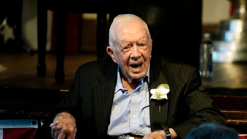 FILE - Former President Jimmy Carter reacts as his wife Rosalynn Carter speaks during a...