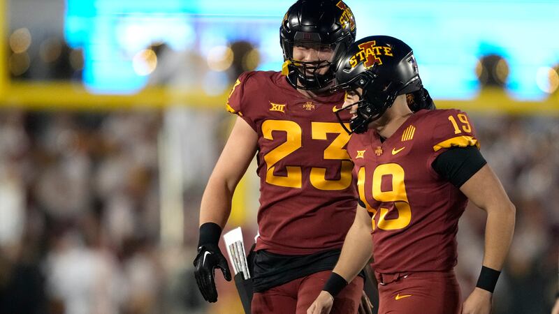 Iowa State linebacker Will McLaughlin (23) congratulates place-kicker Chase Contreraz (19) on...