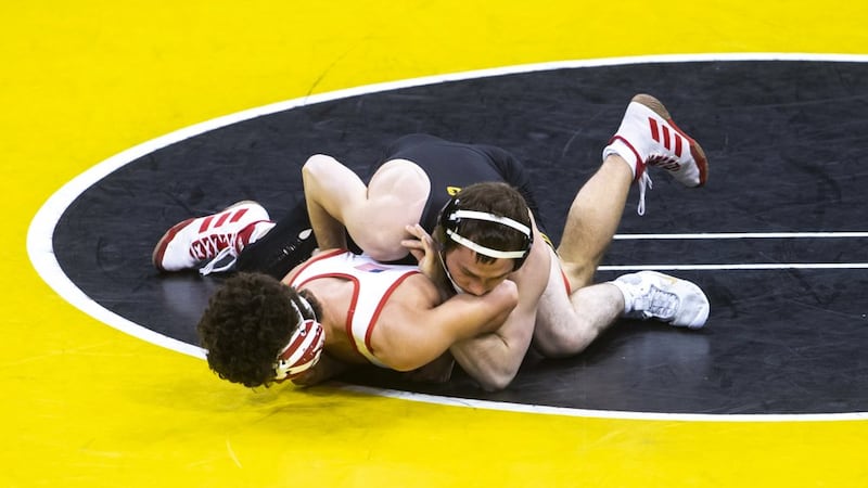 FILE — Iowa's Spencer Lee, top, wrestles Nebraska's Liam Cronin at 125 pounds during a Big Ten...