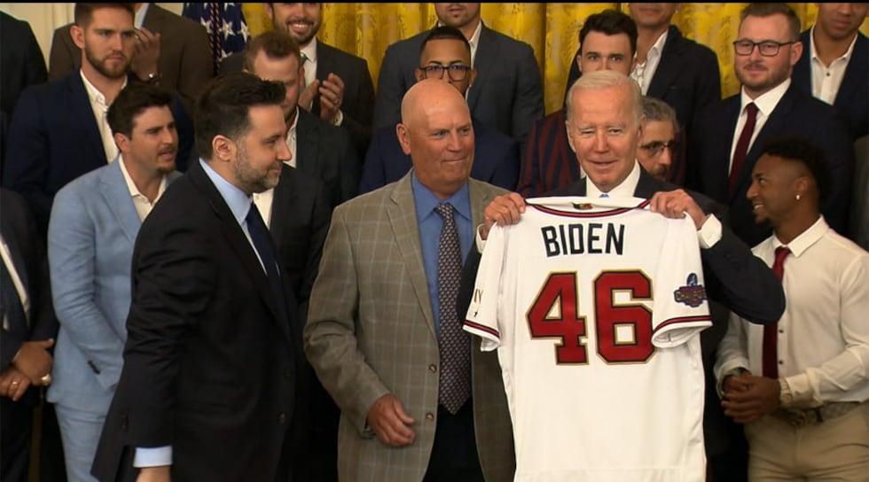 Members of the Atlanta Braves organization present President Joe Biden with a special jersey...