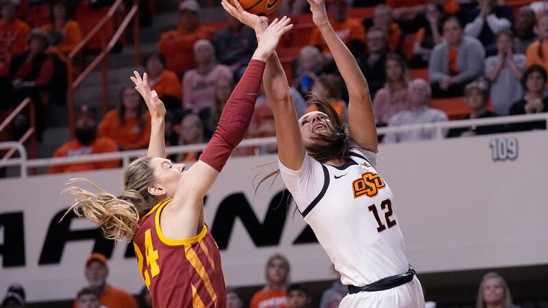 Oklahoma State guard Claire Chastain (12) shoots in front of Iowa State guard Ashley Joens...