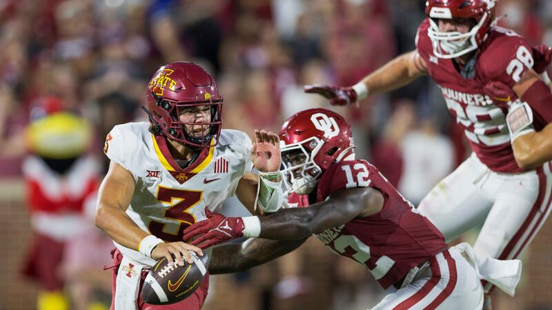 Oklahoma defensive back Key Lawrence (12) pressures Iowa State quarterback Rocco Becht (3)...