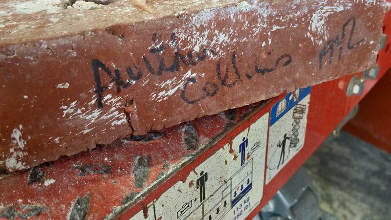 A brick with the signature of Collins Radio founder Arthur Collins discovered by construction...