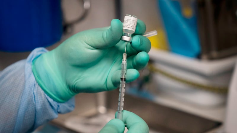 FILE - In this Thursday, Aug. 26, 2021 file photo, a syringe is prepared with the Pfizer...
